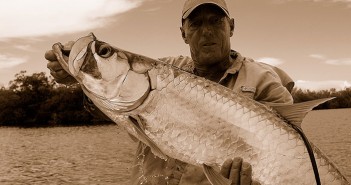 A man holding up a fish.