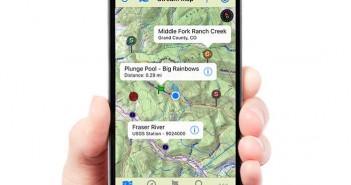 A person holding up a smartphone with a map on it.