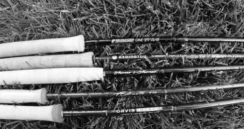 A black and white photo of a group of fishing rods.