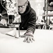 A man working on a machine in a warehouse.