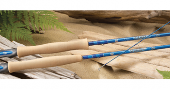 A pair of fishing rods on a log.