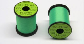 Two spools of green thread.