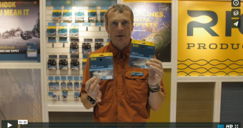 A man holding up a pack of rr products.