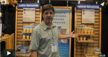 A man standing in front of a display of products.