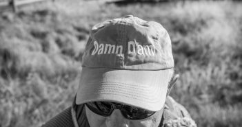 A man wearing a hat with the word democracy'' on it.