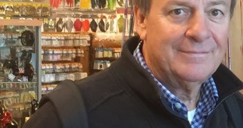 A man in a jacket standing in a store.