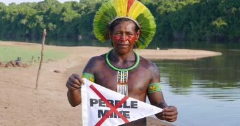 A man holding a sign that says people no.