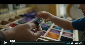 A child is putting a piece of string into a drawer.