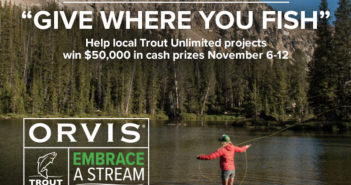 A man is fishing in a stream with the words give where you fish.