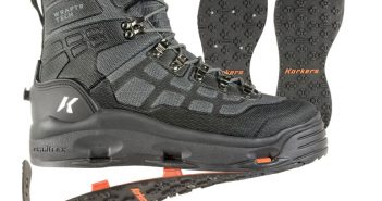 A pair of black boots with orange soles.