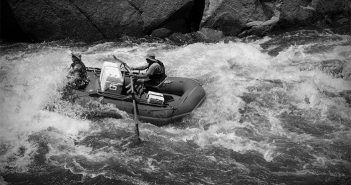 A group of people rafting down a river.