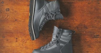 A pair of grey boots on a wooden surface.