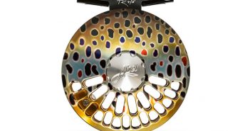 A fly reel with gold dots on it.