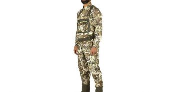 A man in a camouflage outfit standing on a white background.