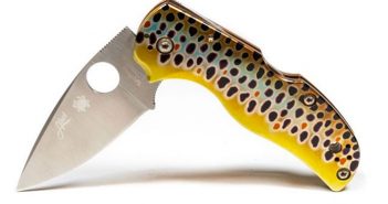 A knife with a yellow handle and a black handle.