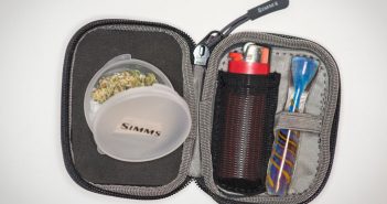 A black case with a lighter and a toothbrush inside.