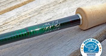 A green fly rod with a wooden handle.