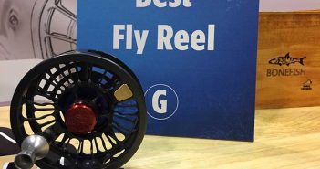 A fly reel on a table with a sign that says best fly reel.