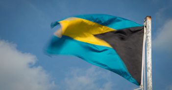 The flag of bahamas flies in the wind.