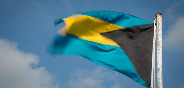 The flag of bahamas flies in the wind.