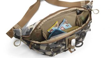 A camouflage fanny pack with a lot of compartments.