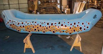 A blue raft with polka dots painted on it.