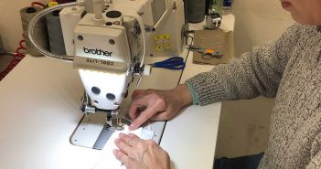A woman working on a sewing machine.