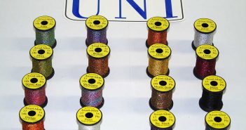 A group of spools of different colors of thread.