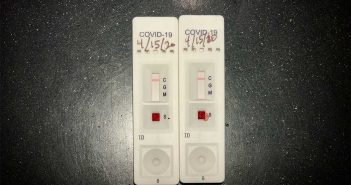 A pair of coronavirus test kits sitting on a table.