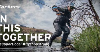 A man is fishing in a river with the words in this together.