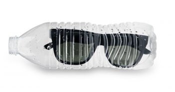 Sunglasses in a plastic bottle on a white background.