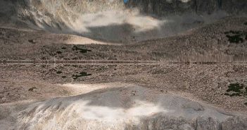 A mountain range is reflected in a mirror.