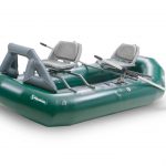 A green raft with two seats and two paddles.