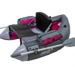 A gray and pink raft with paddles and oars.