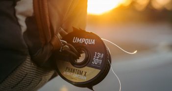 A backpack with a cd attached to it.