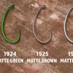 Four different types of hooks are shown on a piece of stone.