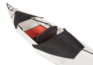 A white and orange kayak with a seat.