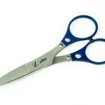 A pair of scissors with blue handles on a white surface.