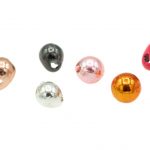 A variety of colored metal beads on a white background.
