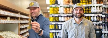 Two men standing in front of a display of flies.
