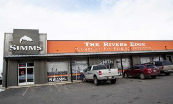 The simms river's edge store is parked outside.