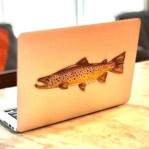 A laptop with a brown trout sticker on it.