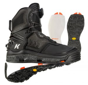 A pair of black boots with orange soles.