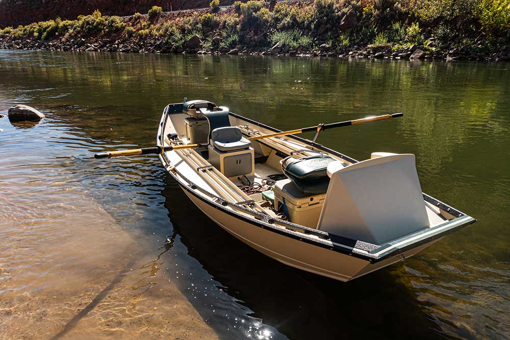 A small boat is moored in a river.