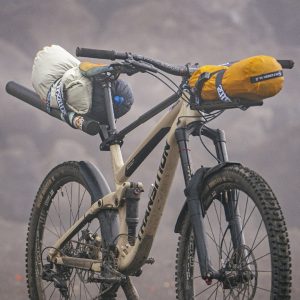 A mountain bike with a bag attached to it.