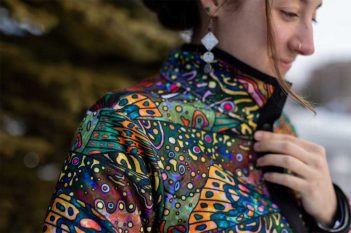 A woman wearing a colorful jacket.