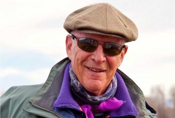 An older man wearing a hat and sunglasses.