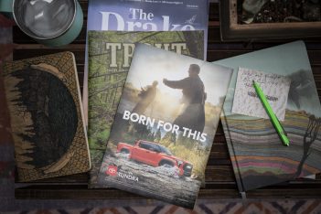 A group of books on a table next to a cup of coffee.