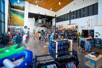 The inside of a store with a lot of outdoor gear.