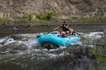 A group of people rafting down a river.